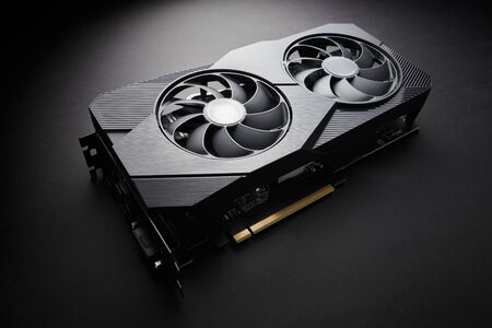 modern black computer video card on a black background, deep shadows and contrasting light, one...
