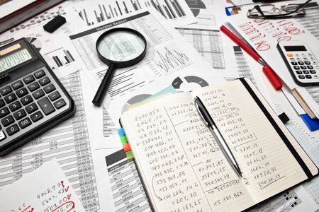 Top view of office worker's desk - work with financial reports, analysis and accounting, tables and...