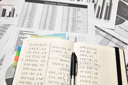 Top view of office worker's desk - work with financial reports, analysis and accounting, tables and...