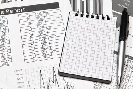 Top view of office worker's desk - work with financial reports, analysis and accounting, tables and...
