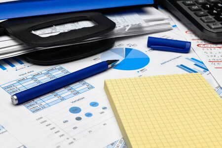 business office desk closeup - financial reports, analysis and accounting, set of documents, tables...