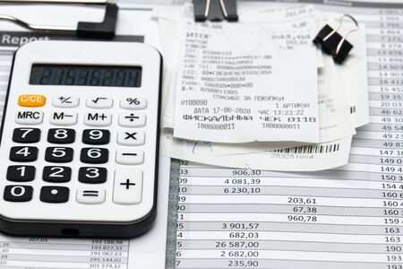cash registers purchase receipt, calculator and financial reports, analysis and accounting, various office items for bookkeepingの写真素材
