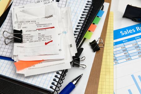 business office desk closeup - financial reports, analysis and accounting, set of documents, tables and graphs, various items for bookkeeping, calculatorの写真素材