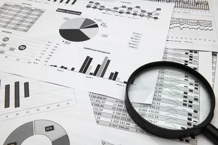 business office desk closeup - financial reports, analysis and accounting, set of documents, tables...