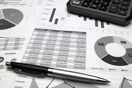 business office desk closeup - financial reports, analysis and accounting, set of documents, tables...
