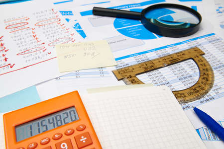 business office desk closeup - financial reports, analysis and accounting, set of documents, tables...