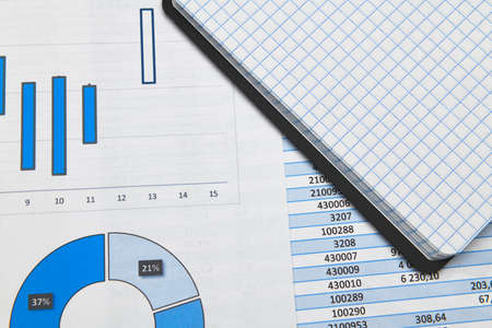 business office desk closeup - financial reports, analysis and accounting, set of documents, tables and graphs, various items for bookkeeping, calculatorの写真素材