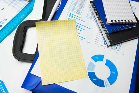 business office desk closeup - financial reports, analysis and accounting, set of documents, tables and graphs, various items for bookkeeping, calculatorの写真素材