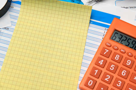 business office desk closeup - financial reports, analysis and accounting, set of documents, tables and graphs, various items for bookkeeping, calculatorの写真素材