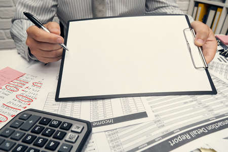 Business analysis and accounting concept - businessman working with document, spreadsheet, using...