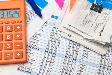 business office desk closeup - financial reports, analysis and accounting, set of documents, tables and graphs, various items for bookkeeping, calculatorの写真素材