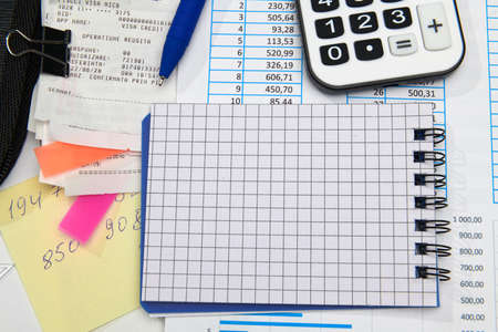 business office desk closeup - financial reports, analysis and accounting, set of documents, tables and graphs, various items for bookkeeping, calculatorの写真素材