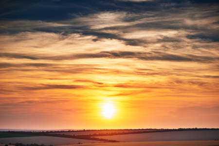 wheat field in a beautiful sunset, sunlight and cloudsの写真素材
