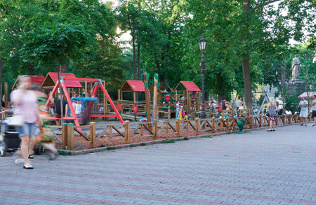 Odessa, Ukraine - August 4, 2020: Children's Playground in the city Park at the Cathedral square, summer evening, children with their parents relax and play, street photoのeditorial素材