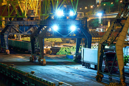 view of the industrial port at night - ships waiting for loading and unloading, cargo transportation...