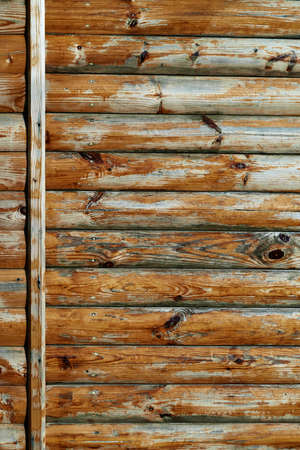 old weathered wooden planks as a brown background, peeling paint and cracksの写真素材