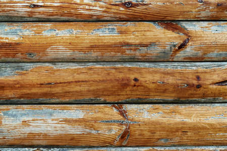 old weathered wooden planks as a brown background, peeling paint and cracksの写真素材