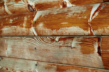 old weathered wooden planks as a brown background, peeling paint and cracksの写真素材