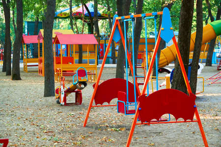 children's playground in a city Park early in the morning, various swings and carousels