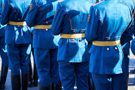 military parade in a city, soldiers in full dress uniforms ordered in parade formation, russian text...