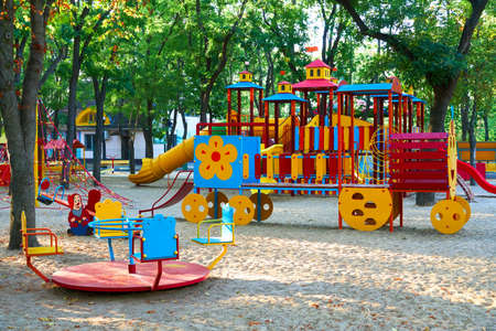 children's playground in a city Park early in the morning, various swings and carousels
