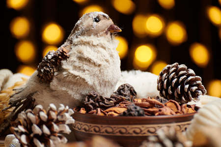 christmas decoration in rustic style and holiday lights background, still life on dark backdrop, a stuffed bird and otherの写真素材