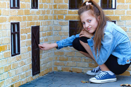 teen girl posing near fountain in a city park, bright summer dayの写真素材