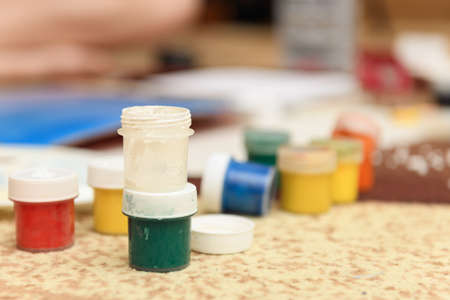 watercolor paints and paper closeup for drawing, artistic creation at home, workspace for make creative artworkの写真素材