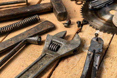 Variety of old vintage household hand tools still life on a wooden background in a DIY and repair conceptの写真素材