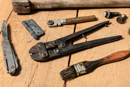 Variety of old vintage household hand tools still life on a wooden background in a DIY and repair conceptの写真素材