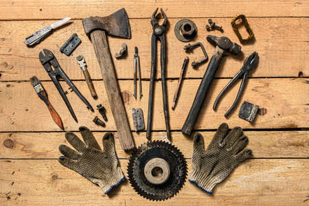 Variety of old vintage household hand tools still life on a wooden background in a DIY and repair conceptの写真素材