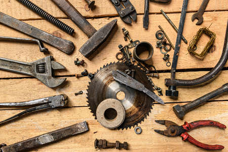 Variety of old vintage household hand tools still life on a wooden background in a DIY and repair...