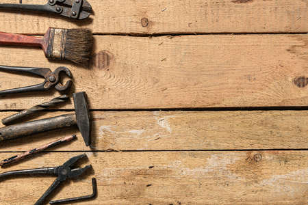 Old vintage household hand tools still life on a wooden background with copyspace and place for text
