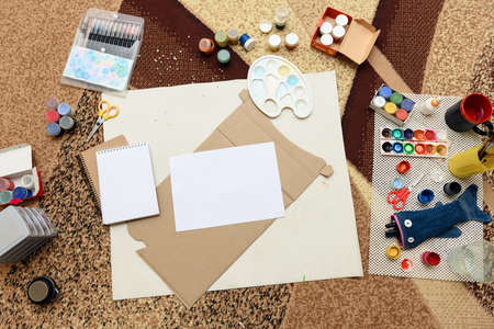 watercolor paints and paper closeup for drawing, artistic creation at home, workspace for make creative artworkの写真素材