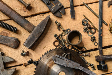 Variety of old vintage household hand tools still life on a wooden background in a DIY and repair...