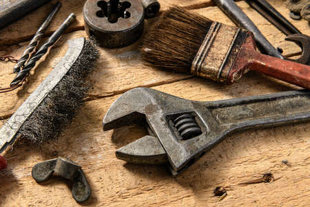 Old vintage household hand tools still life on a wooden background in a DIY and repair concept