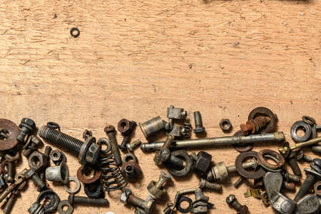 Old vintage household bolts, nuts and hand tools still life on a wooden background in a DIY and repair conceptの写真素材