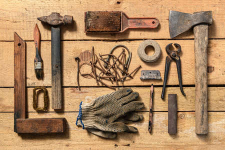 Old vintage household hand tools still life on a wooden background in a DIY and repair conceptの写真素材