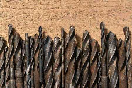 old vintage hand tools - set of drills on a wooden background with blank space for text