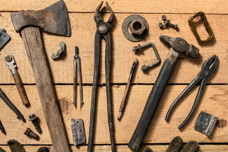 Variety of old vintage household hand tools still life on a wooden background in a DIY and repair conceptの写真素材