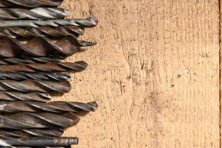 old vintage hand tools - set of drills on a wooden background with blank space for text