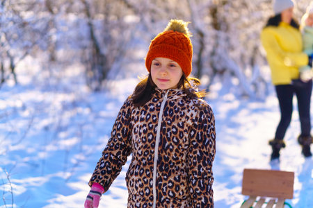 family portrait in the winter forest, mother and children, bright sunlight and shadows on the snow, beautiful nature.の写真素材