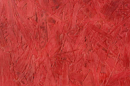 the wooden background is painted red, new and clean surface, pressed plate made of pieces of wood