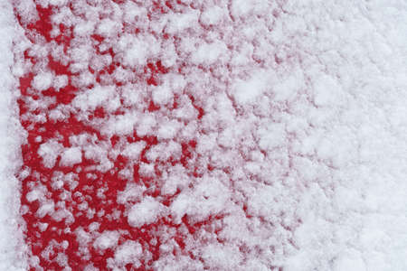 the wooden background is painted red, covered snow in winter outdoor, new and clean surface, pressed plate made of pieces of woodの写真素材