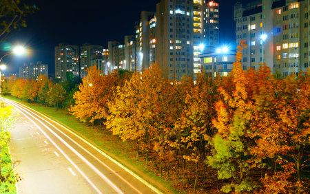 autumn in the city, night and street lights along the road, light in the windows of housesの写真素材