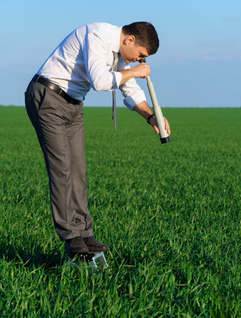 businessman sits in an office chair in a field and rests, freelance and business concept, green...
