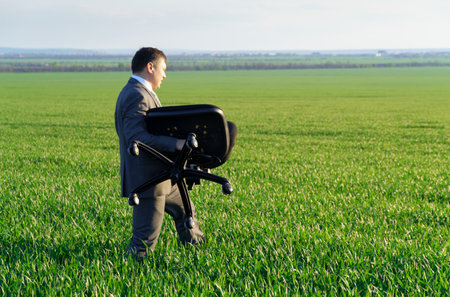 businessman works in a green field, freelance and business concept, green grass and blue sky as backgroundの写真素材