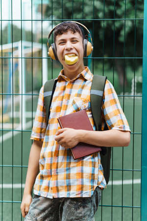teen boy portrait on the way to school, education and back to school concept