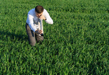 businessman carries an office chair in a field to work, freelance and business concept, green grass...