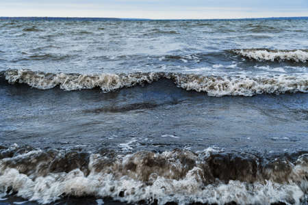 dramatic seascape, gloomy sea and waves, dark moody sky, wild landscape of late autumn, cloudy...